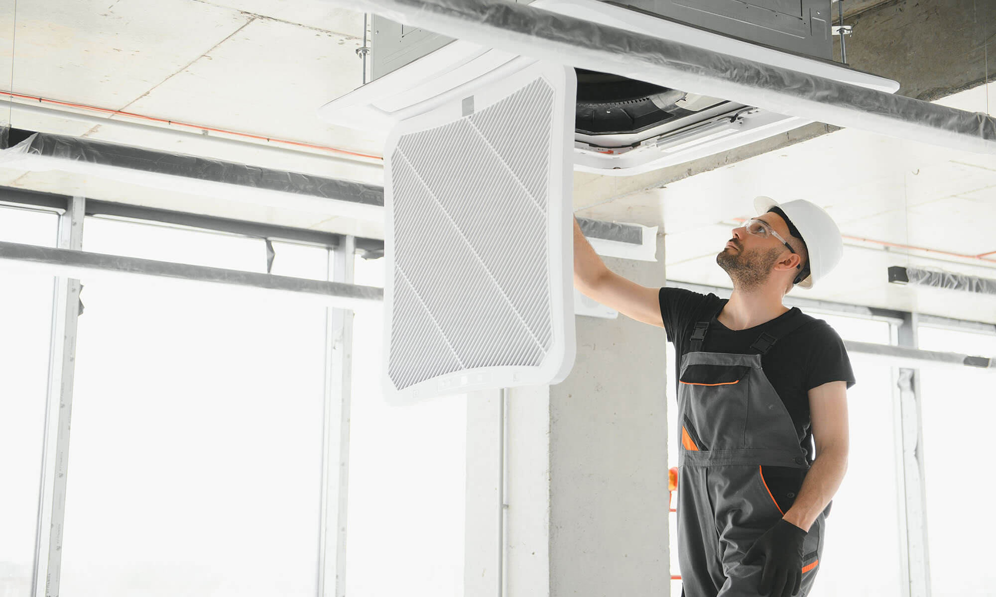 worker-repairing-ceiling-air-conditioning